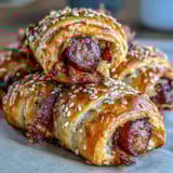 Warm golden pigs in a blanket with flaky pastry and cocktail sausages, served with a tangy honey mustard dip.