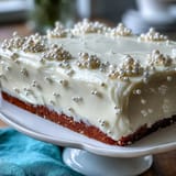 2. Beautifully decorated sheet cake covered in pearl fondant, adorned with edible pearls for a festive Communion party dessert.  