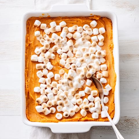 Sweet Potato Casserole with a crunchy pecan streusel topping is baked until bubbling.