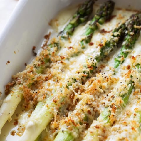 Golden breadcrumb topping bubbling over a freshly baked Asparagus Casserole.