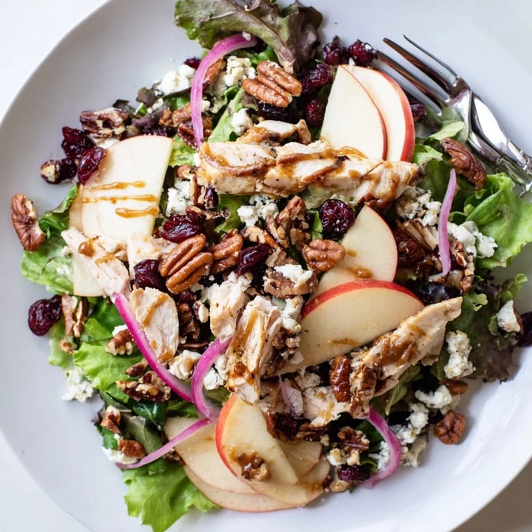 Gluten-free Caramel Apple Chicken Salad plated with golden pecans, feta crumbles, and fresh apple slices, ready to serve with a side of warm bread.
