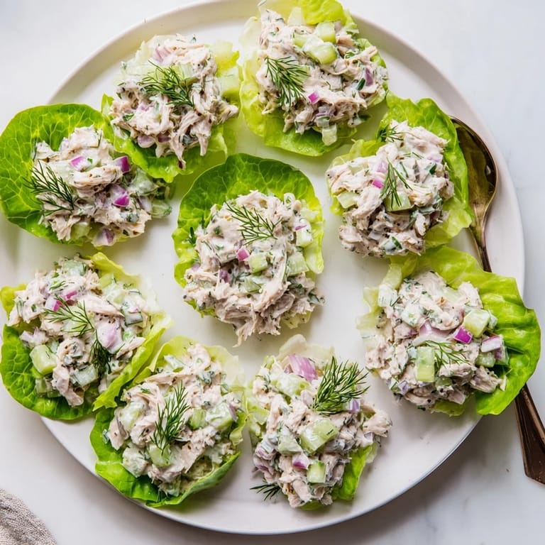 Dill Pickle Chicken Salad Lettuce Cups ready to serve, with creamy dressing and crunchy pickles.
