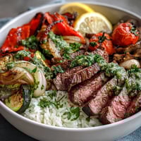 Vibrant sheet pan steak and veggie bowl with juicy grilled steak, colorful roasted vegetables, and fluffy rice.  