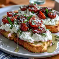 Creamy burrata and sweet peach slices drizzled with honey on rustic sourdough toast, perfect for a fresh spring brunch.